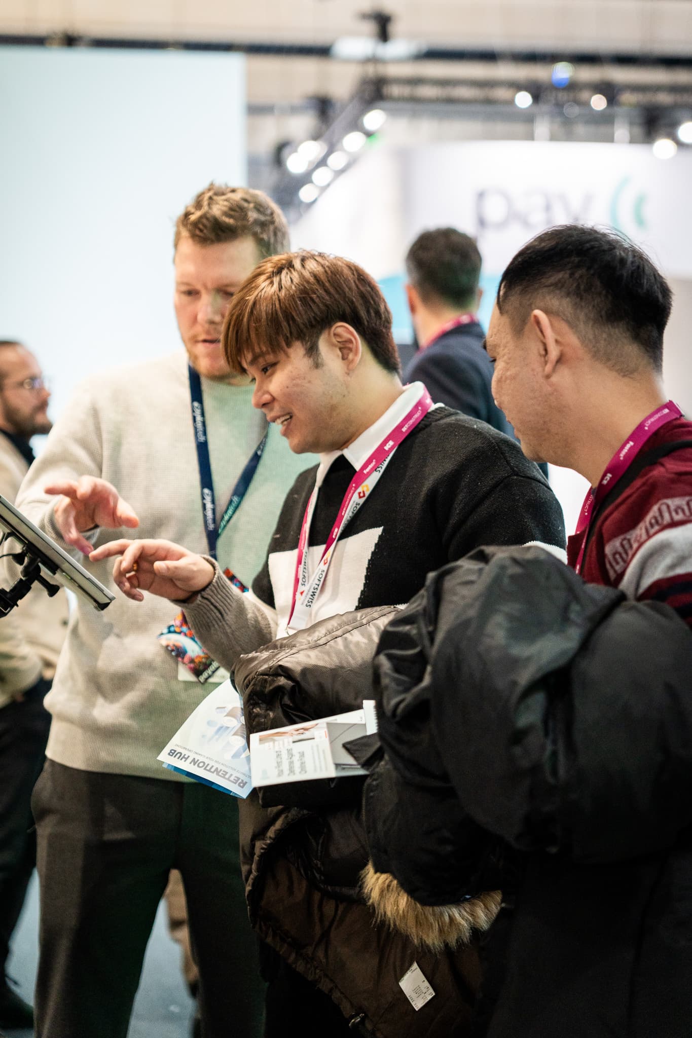 Visitors interacting with the booth at a live event